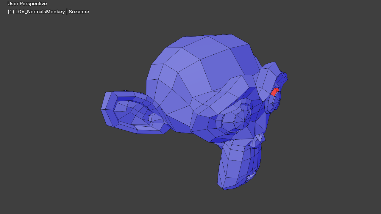 Suzanne monkey head in Blender Edit Mode with the Face Orientation overlay enabled and SOLID shading. The bulk of the mesh is tinted a translucent blue, indicating that the face normals are pointing outward as expected. A small cluster of three adjoining triangle faces on Suzanne's right temple is tinted translucent red, marking those faces as flipped relative to the surrounding mesh. Axis indicators and the world floor grid are visible in the background.