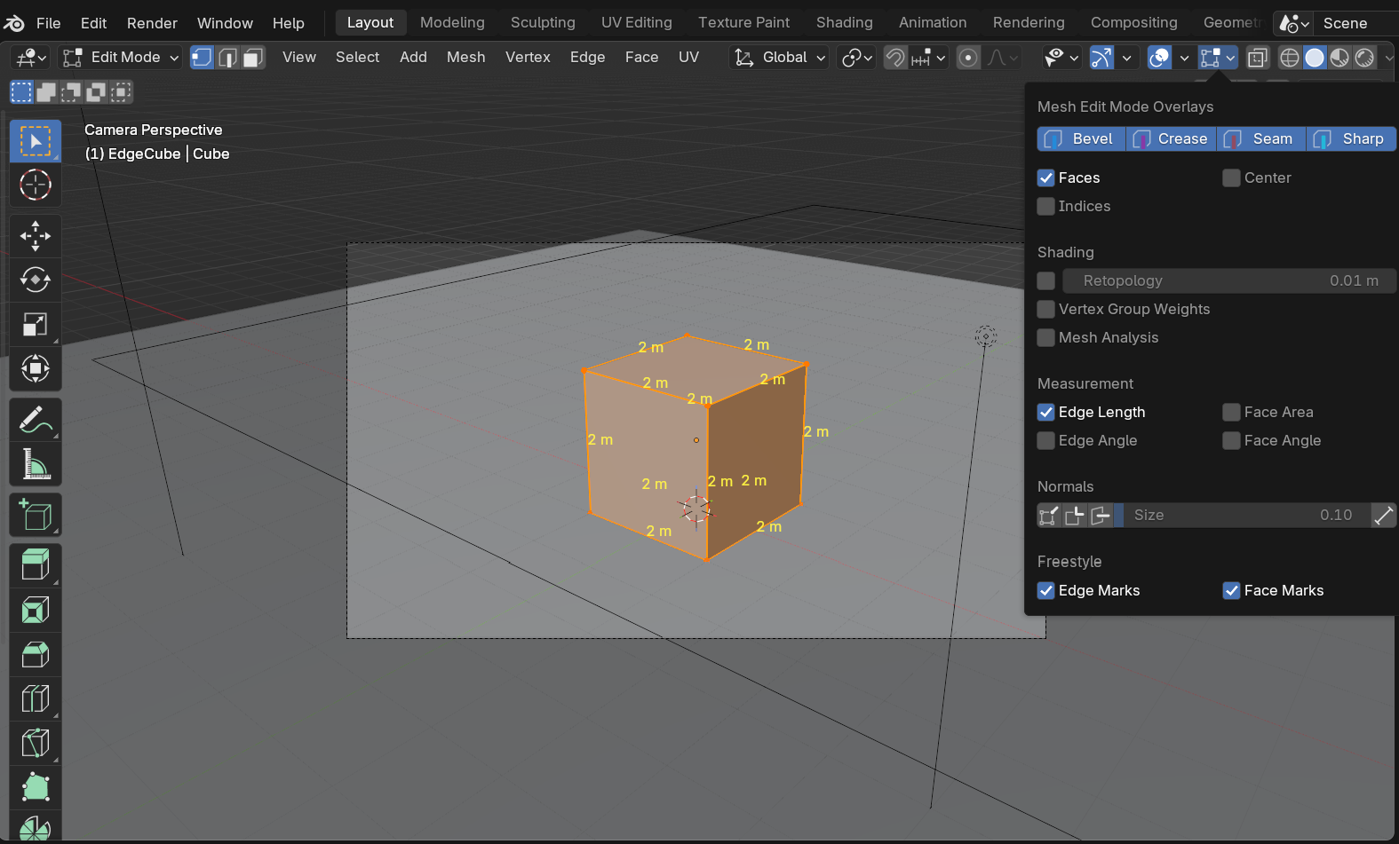 Blender Edit Mode viewport with the Edge Length overlay enabled, showing every edge of a 2-meter cube labeled '2 m', alongside the Mesh Edit Mode Overlays popover with the Edge Length checkbox active.