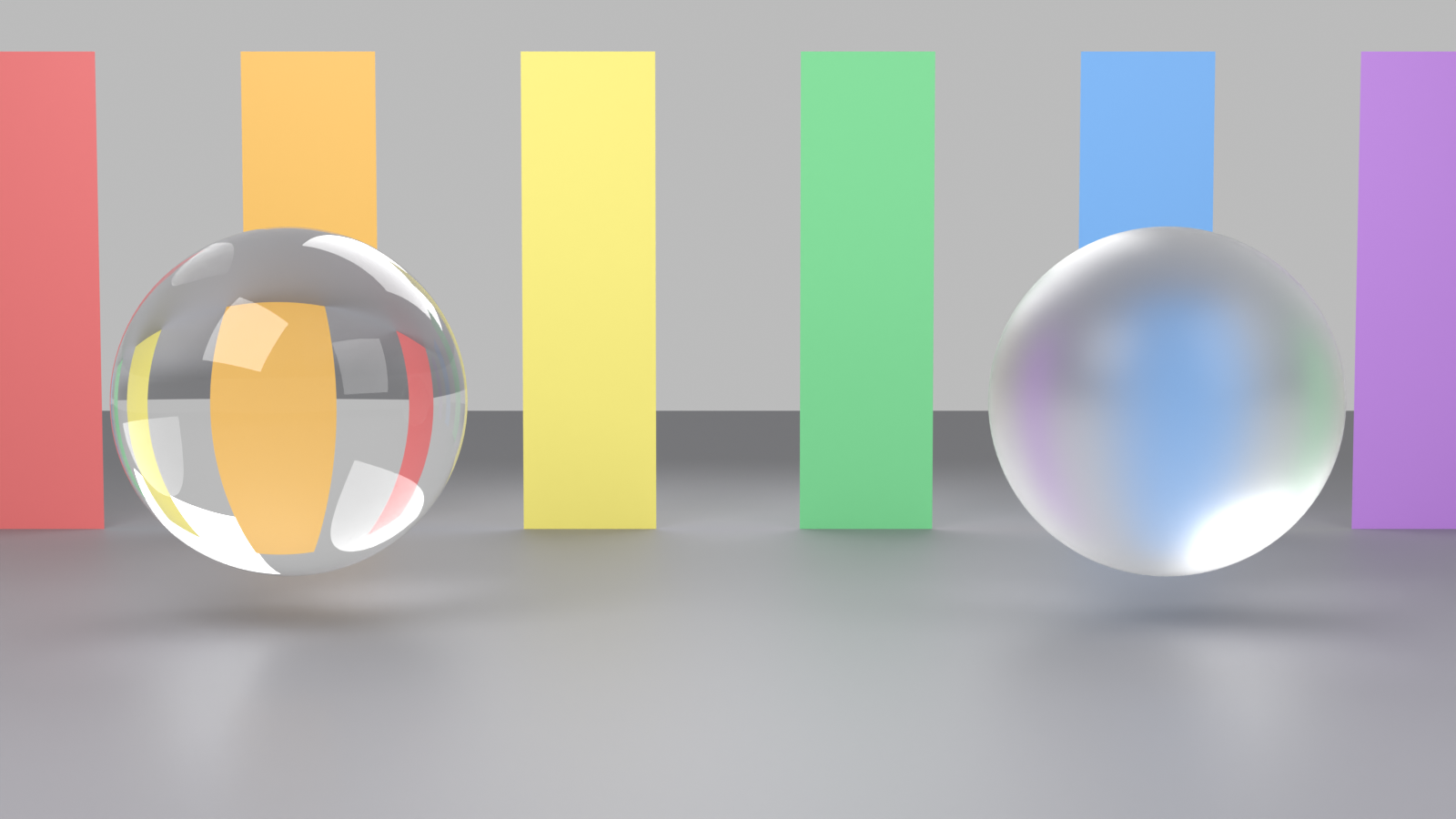 Two glass spheres in front of coloured panels: the left sphere refracts the panels sharply, while the right sphere is frosted and scatters the same view into a soft blur.