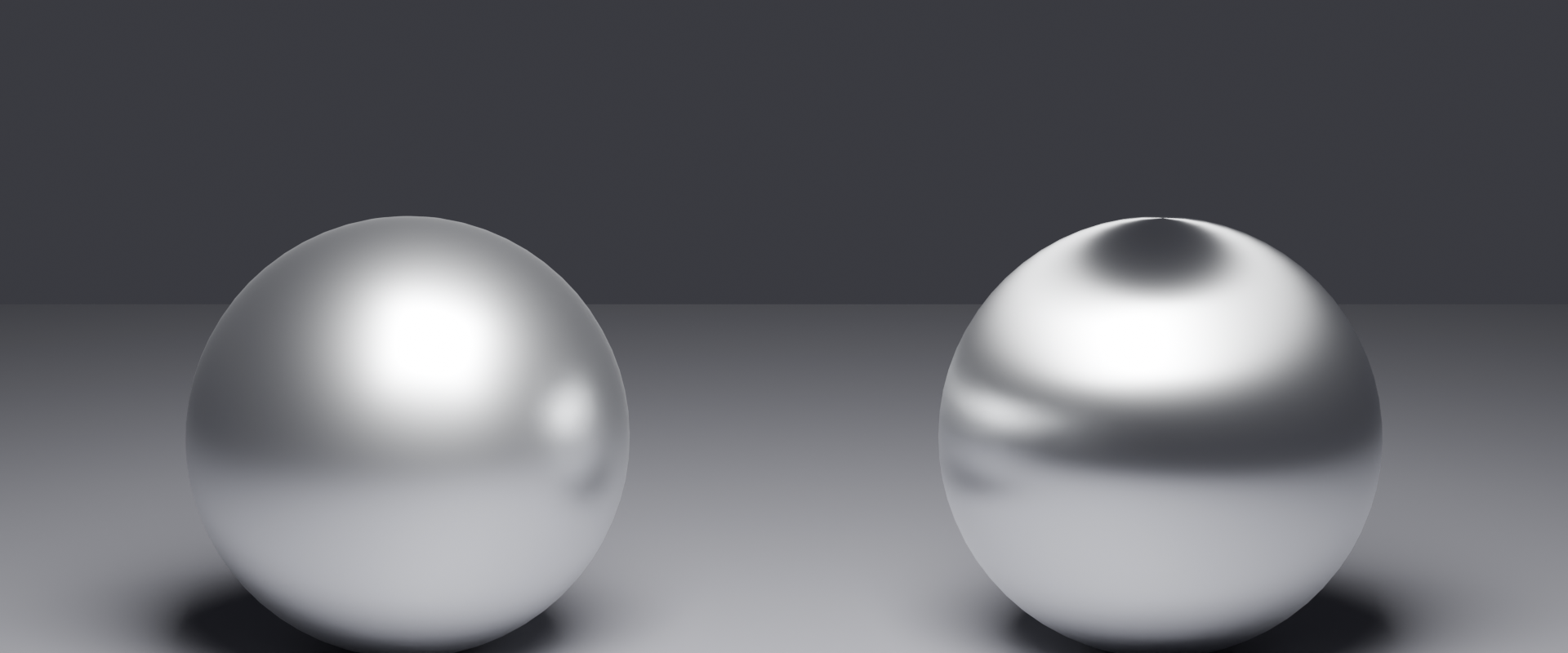 Two metal spheres side by side: left with a compact circular highlight labelled Isotropic 0.0, right with an elongated horizontal highlight labelled Anisotropic 0.9.