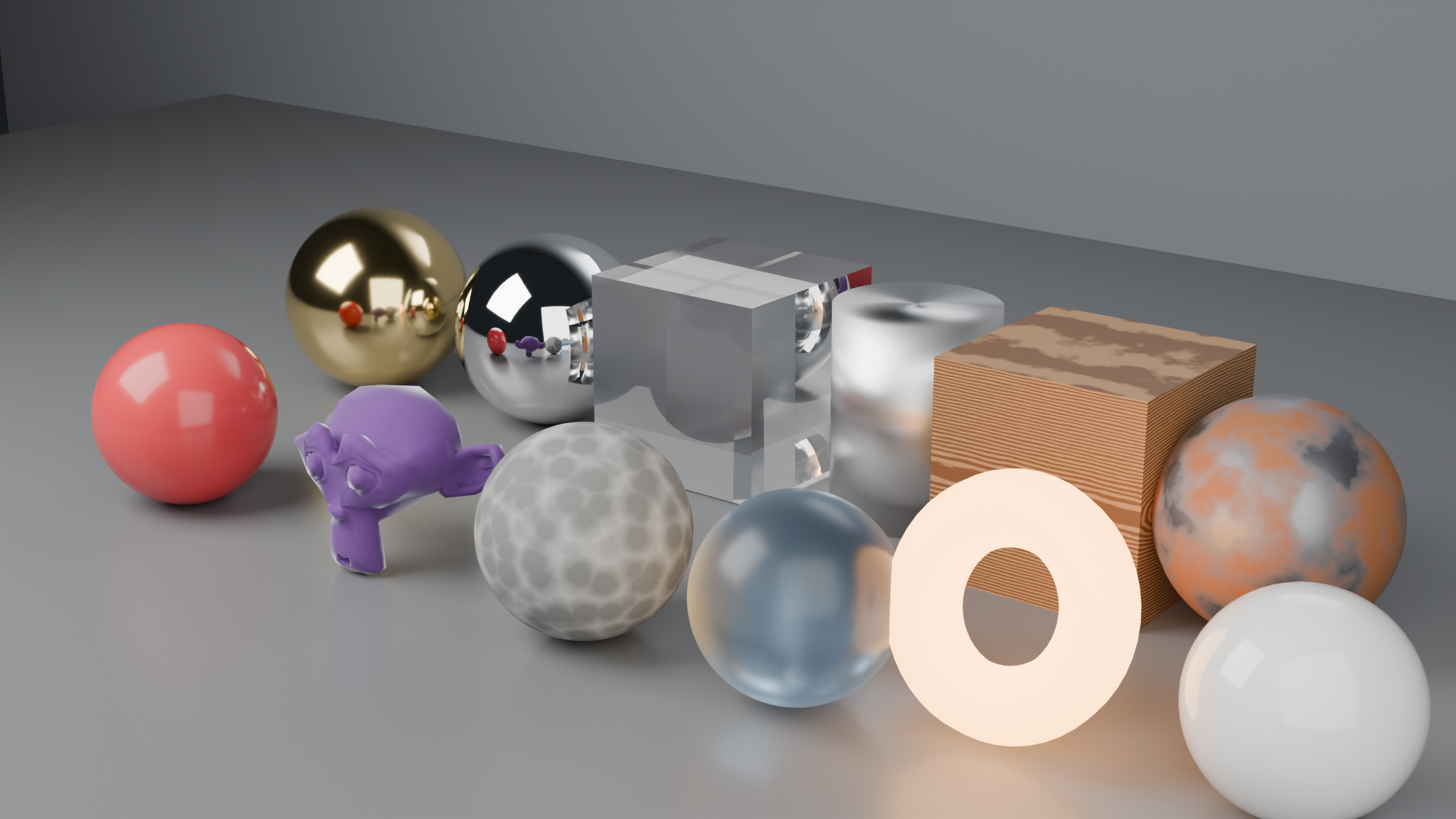 Studio beauty render of twelve objects on a grey platform, each with a different material: polished gold and chrome spheres, a clear glass cube, a brushed aluminum cylinder, a procedural wood cube, glossy red plastic, purple velvet with sheen, rough stone, frosted blue glass, a glowing emissive ring, weathered rusted metal, and white ceramic.